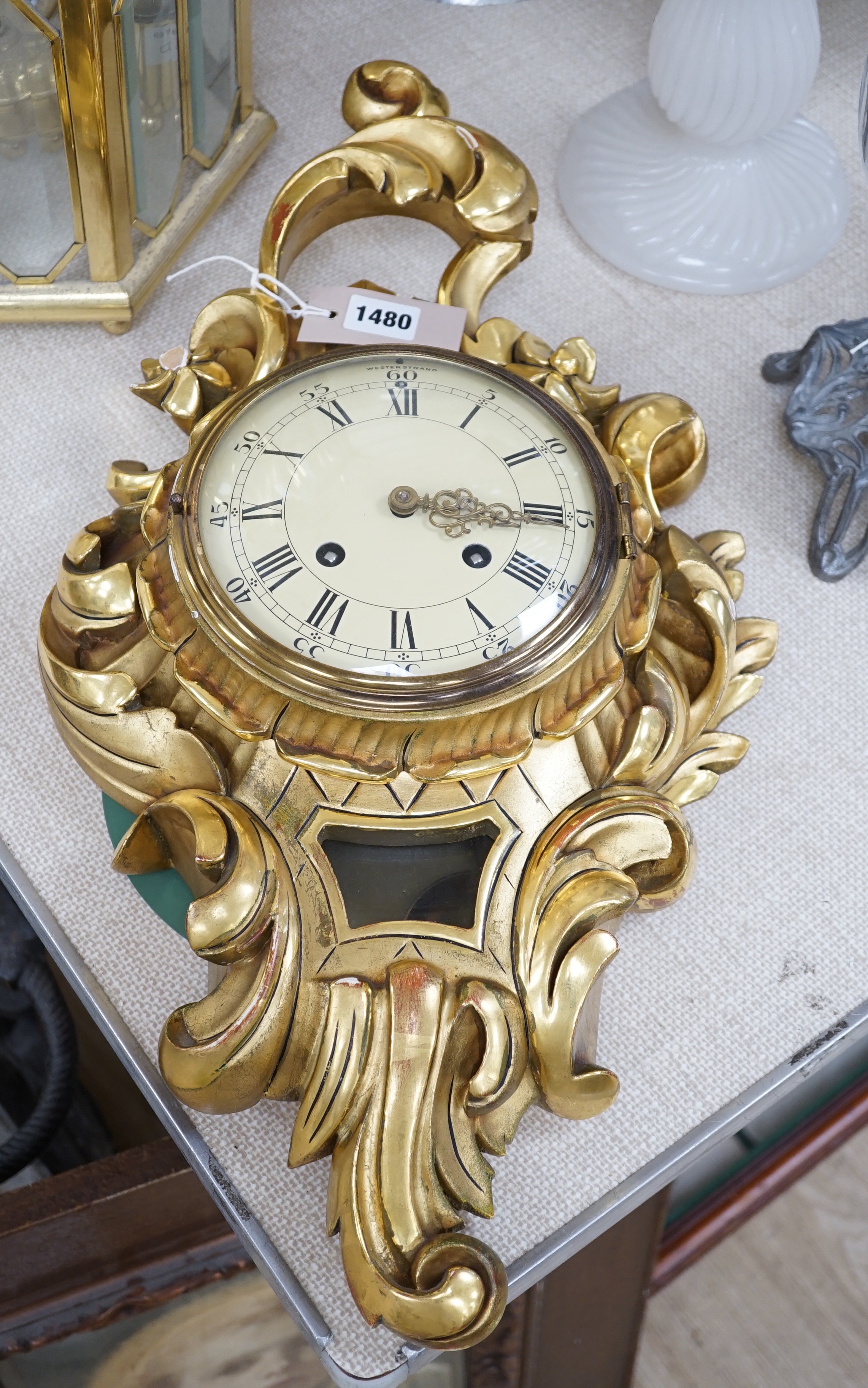 A Swedish giltwood cartouche shaped cartel wall clock, 58cms high